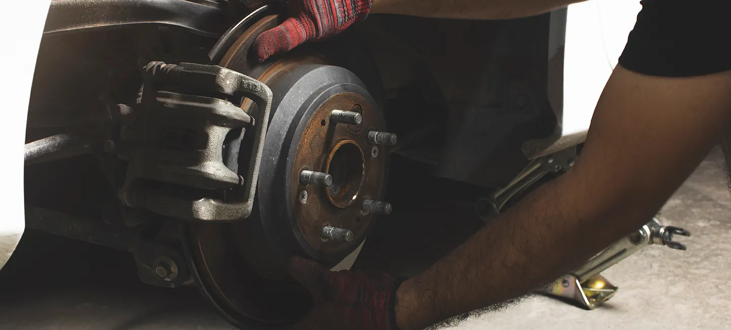Mechanic inspecting brake system for safety and performance